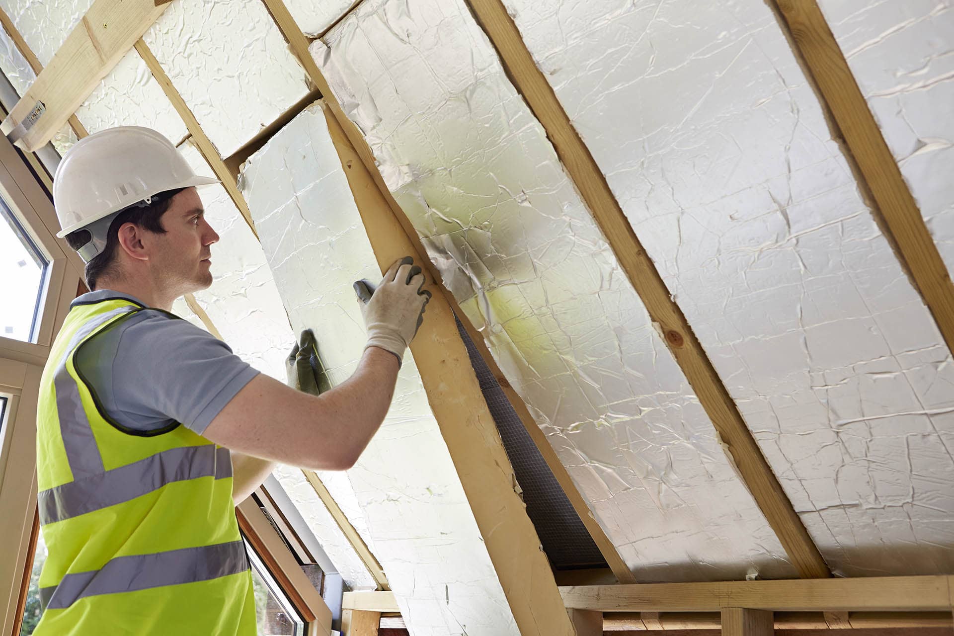 Builder installing block insulating board sheets - building materials